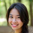 Portrait of Elara Chen, a certified yoga instructor, smiling warmly.