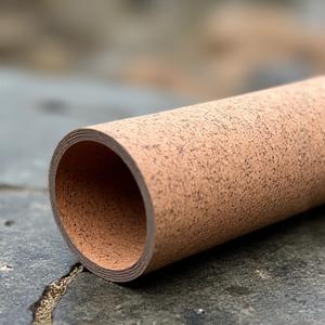 Close-up of a cork and natural rubber EcoGrip Pro mat with visible texture, ideal for outdoor yoga.